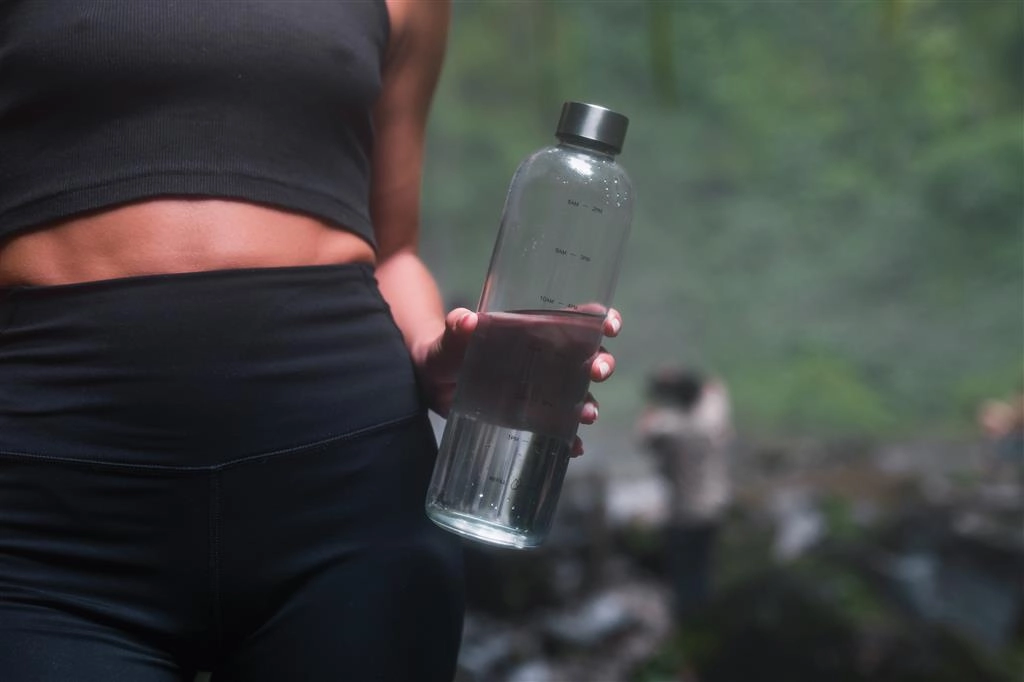 Ein Mädchen hält eine Wassertrinkflasche der Marke Avira in der Hand